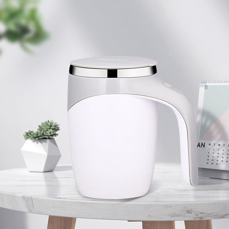 White HOMEFISH self-stirring mug displayed on an office desk.