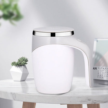 White stainless steel mug styled with tea and a notebook.