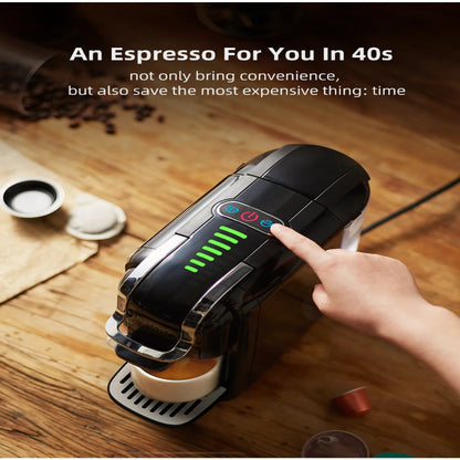 Black espresso machine on a wooden surface with a hand pressing a button, surrounded by coffee beans and a cup.