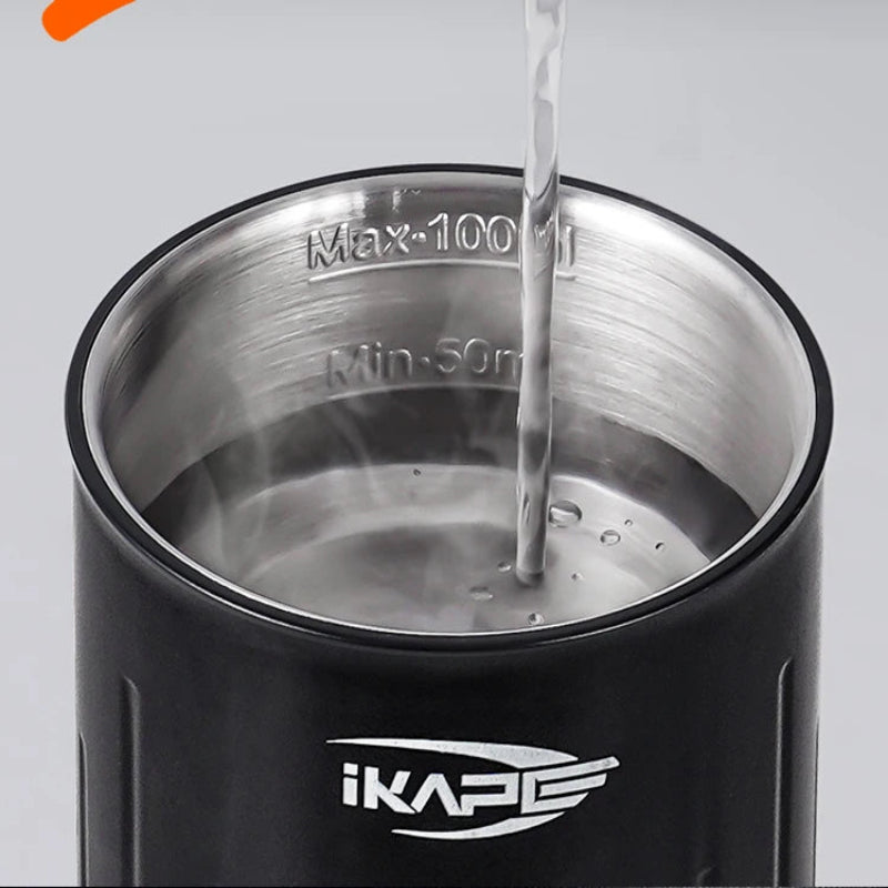 Black thermos with metal interior being filled with water, featuring ikape logo.