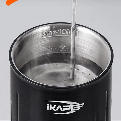 Black thermos with metal interior being filled with water, featuring ikape logo.