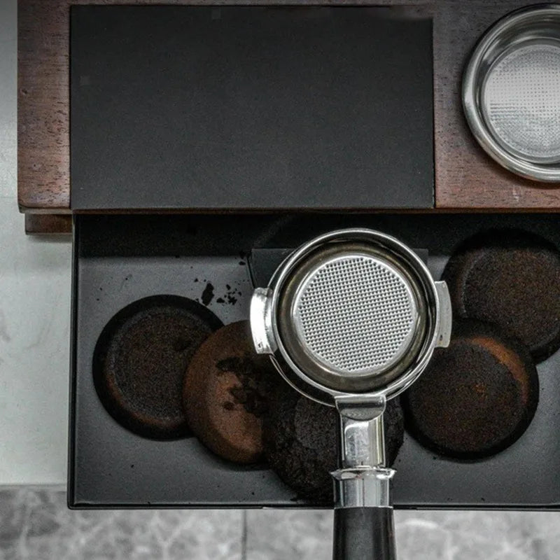 Coffee tamping station with integrated grounds knock box drawer.