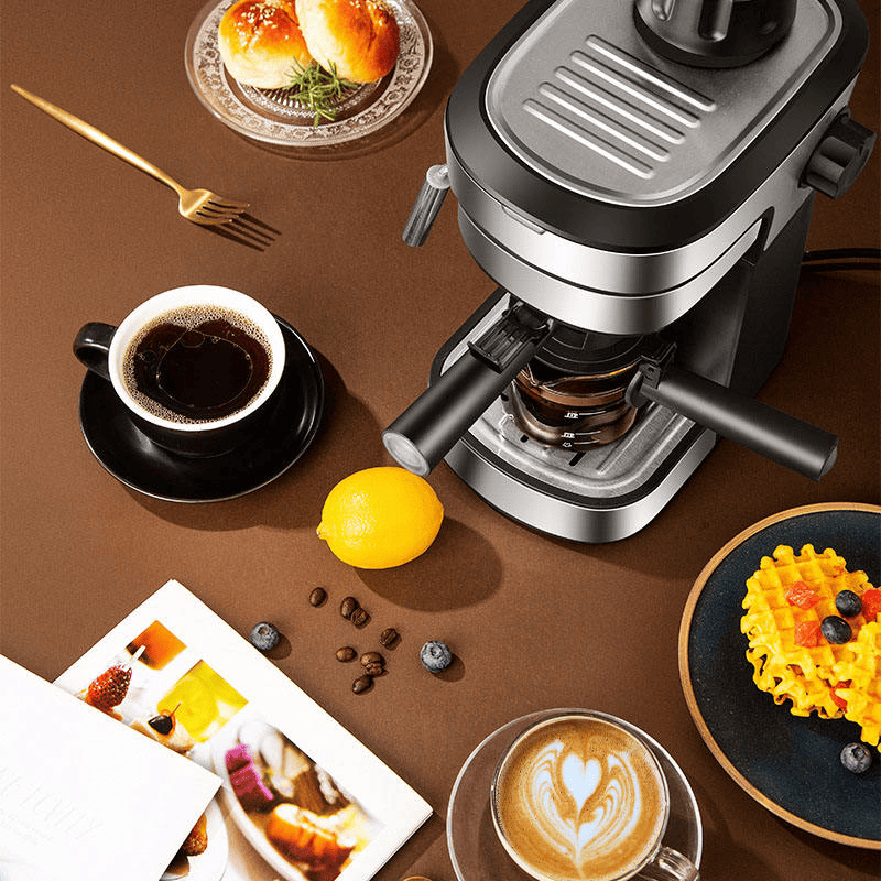 Coffee maker on a table with coffee, lemon, and snacks