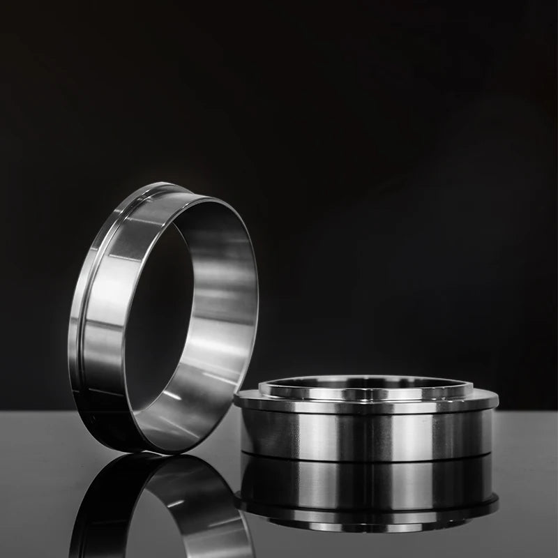 Two metallic rings on a reflective surface with a black background