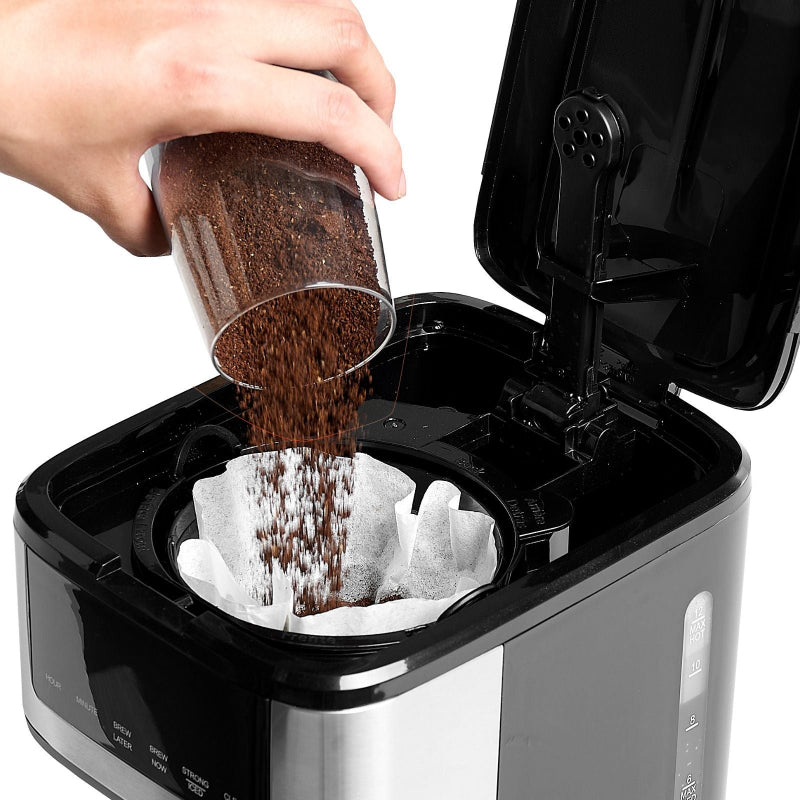 Person pouring coffee grounds into a Vevor 12-cup coffee maker