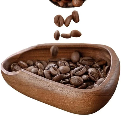 Wooden bowl filled with coffee beans on a white background